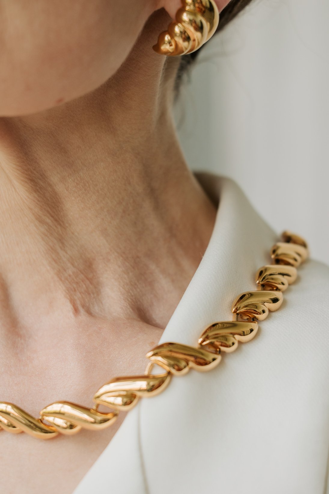 Mature Woman Wearing Gold Earring and Necklace